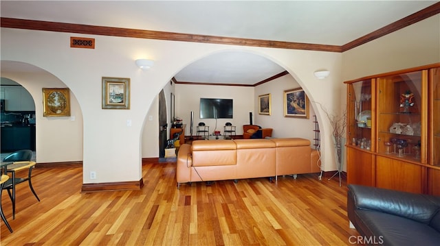 living room with ornamental molding and light hardwood / wood-style floors