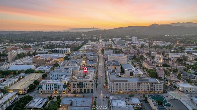 aerial view at dusk featuring a mountain view