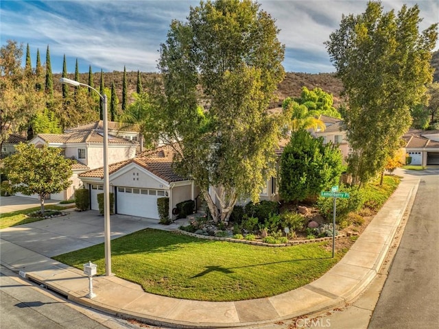 view of front of house with a garage and a front yard