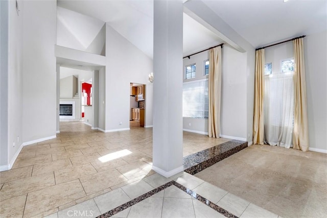 entrance foyer with lofted ceiling and ornate columns