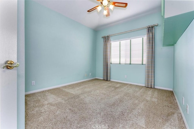 spare room featuring light colored carpet and ceiling fan