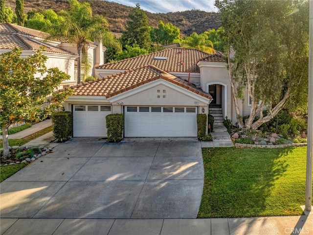 mediterranean / spanish house with a mountain view and a garage