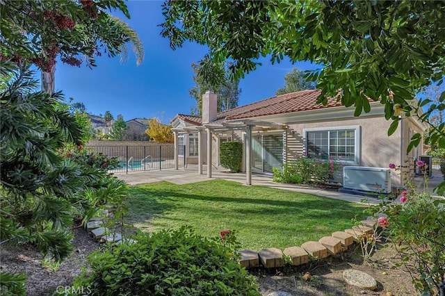 back of house featuring a fenced in pool, a patio, a pergola, and a lawn