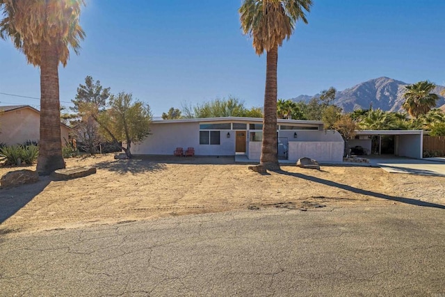 view of front of house featuring a carport and a mountain view