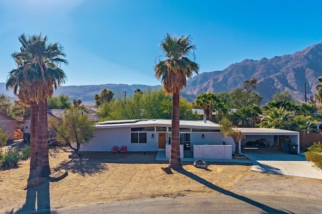 ranch-style home with a carport and a mountain view