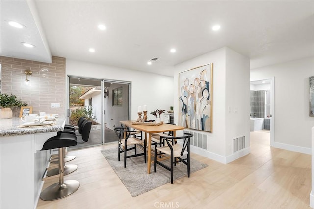 dining space with light wood-type flooring