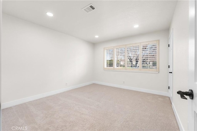 unfurnished room featuring light carpet