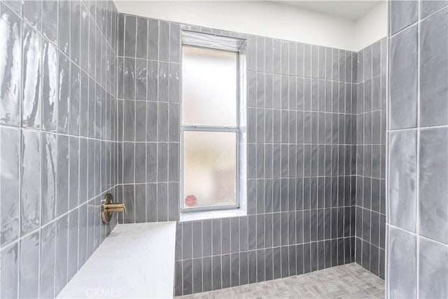 bathroom with tiled shower