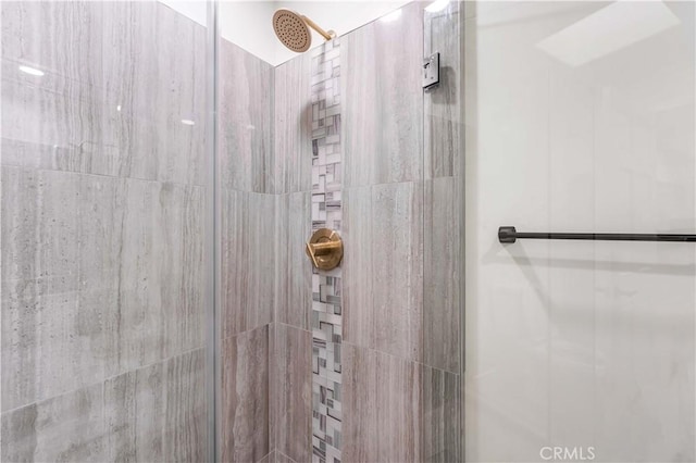 bathroom with a tile shower