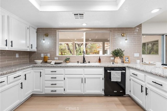 kitchen featuring sink, dishwasher, backsplash, light stone counters, and white cabinets