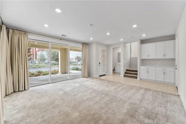 unfurnished living room with light carpet