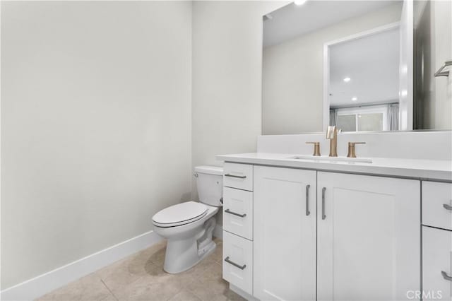 bathroom featuring vanity, toilet, and tile patterned flooring