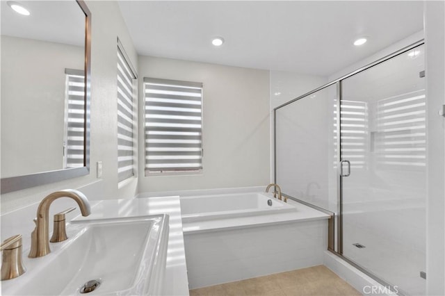 bathroom featuring tile patterned flooring, sink, and plus walk in shower