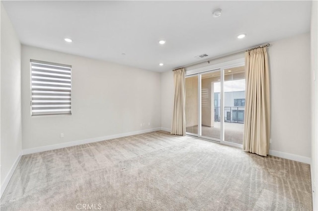 unfurnished room with light colored carpet