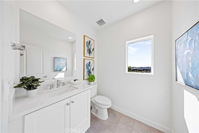 bathroom featuring vanity, tile patterned flooring, and toilet