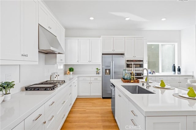 kitchen featuring light hardwood / wood-style flooring, sink, stainless steel appliances, and white cabinets