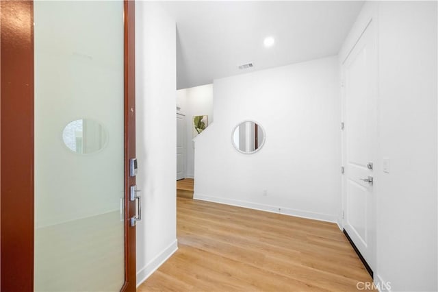 corridor with light hardwood / wood-style flooring