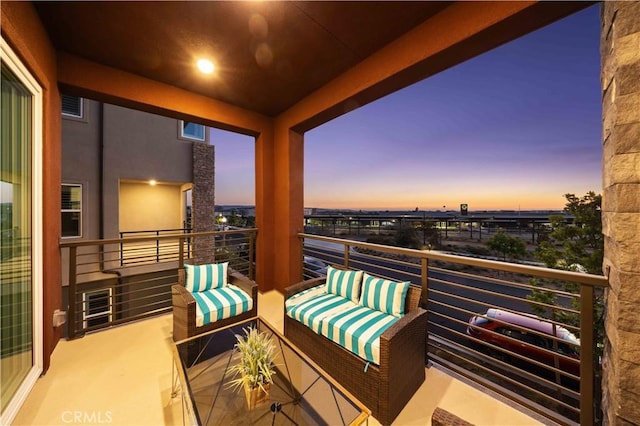 balcony at dusk with an outdoor living space