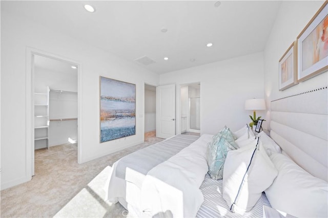 carpeted bedroom with a closet and a walk in closet