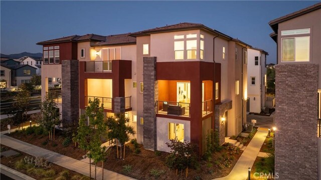 view of side of property with a balcony