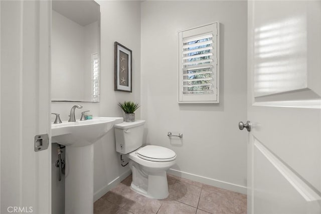 bathroom with tile patterned flooring and toilet