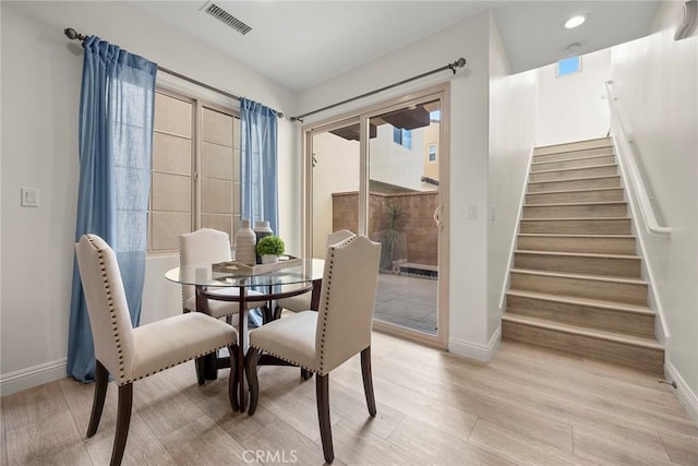 dining area with plenty of natural light and light hardwood / wood-style floors