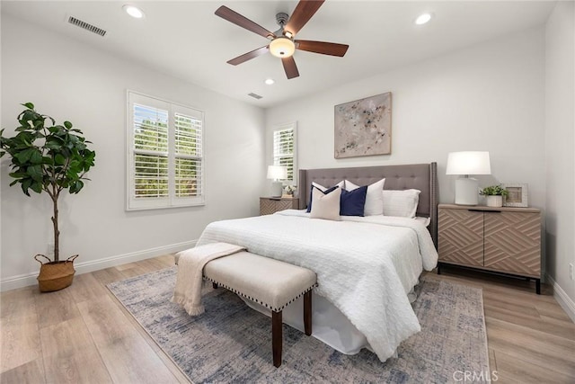 bedroom with light hardwood / wood-style flooring and ceiling fan