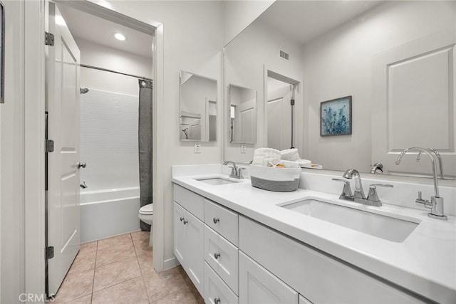 full bathroom featuring vanity, shower / bath combo, tile patterned floors, and toilet