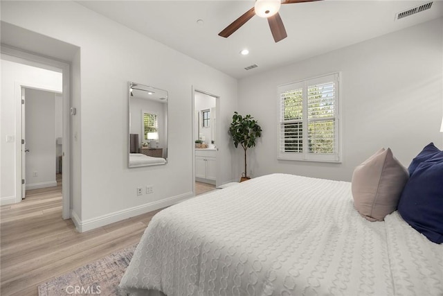 bedroom with ceiling fan, connected bathroom, and light hardwood / wood-style floors