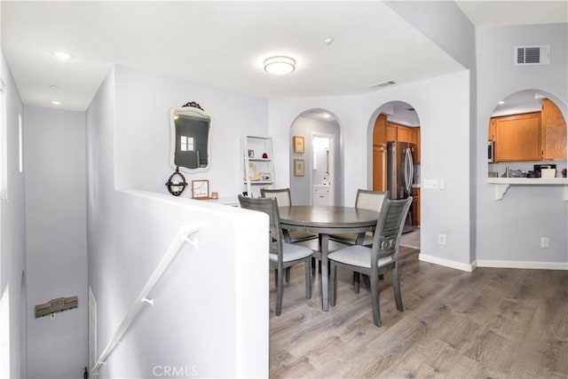 dining space with light hardwood / wood-style floors