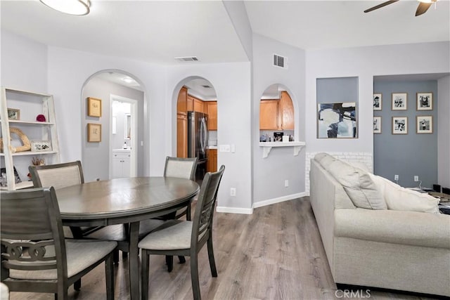 dining area with ceiling fan and light hardwood / wood-style flooring