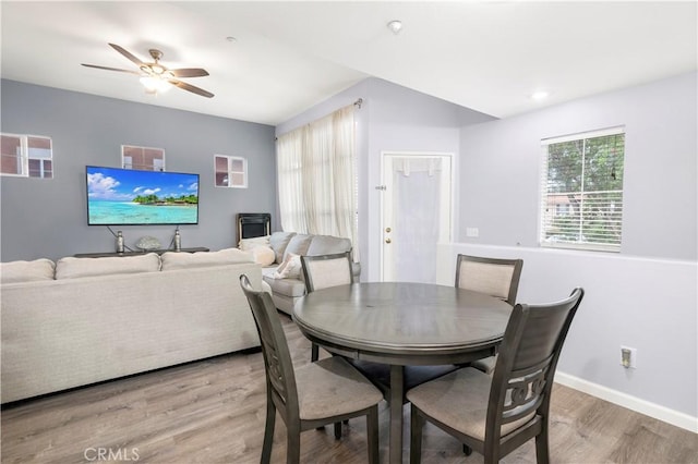 dining area with ceiling fan and light hardwood / wood-style flooring