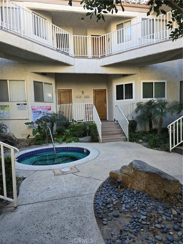 view of swimming pool featuring a community hot tub