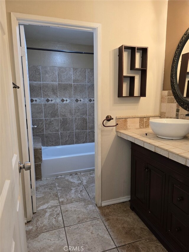 bathroom with vanity and tiled shower / bath combo