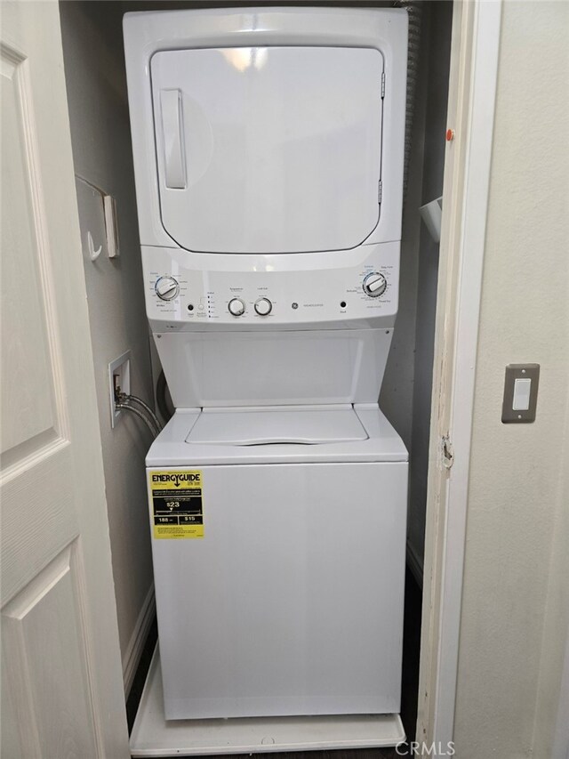 clothes washing area with stacked washer and clothes dryer