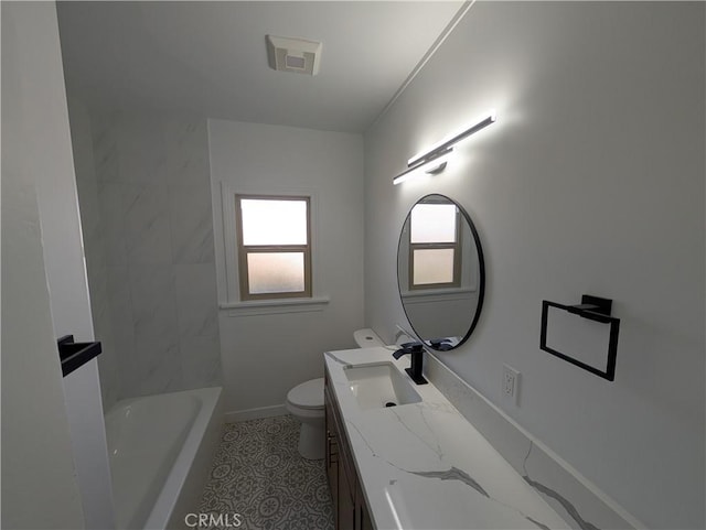 bathroom featuring vanity, tile patterned floors, and toilet