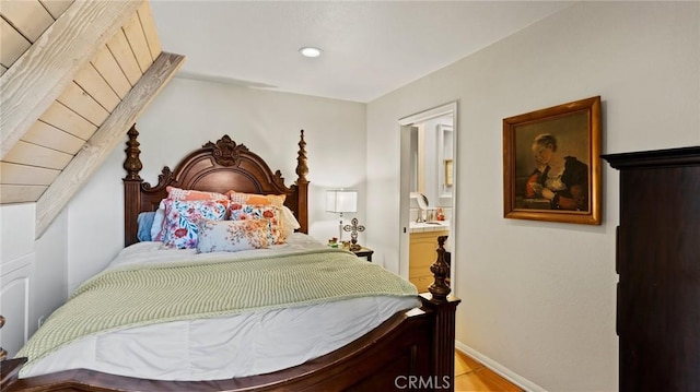 bedroom featuring light hardwood / wood-style floors and ensuite bathroom