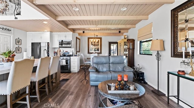 living room featuring beamed ceiling, wood ceiling, dark wood-type flooring, and a notable chandelier