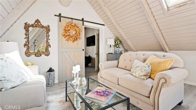 living room featuring wood ceiling, light hardwood / wood-style flooring, lofted ceiling with skylight, and a barn door