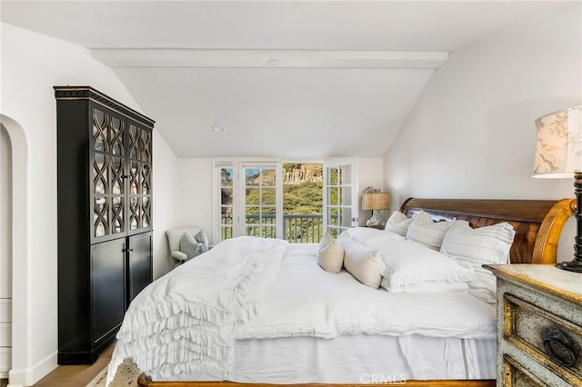 bedroom with light hardwood / wood-style flooring and lofted ceiling with beams