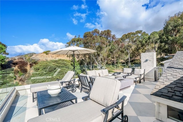 view of patio with an outdoor living space with a fireplace