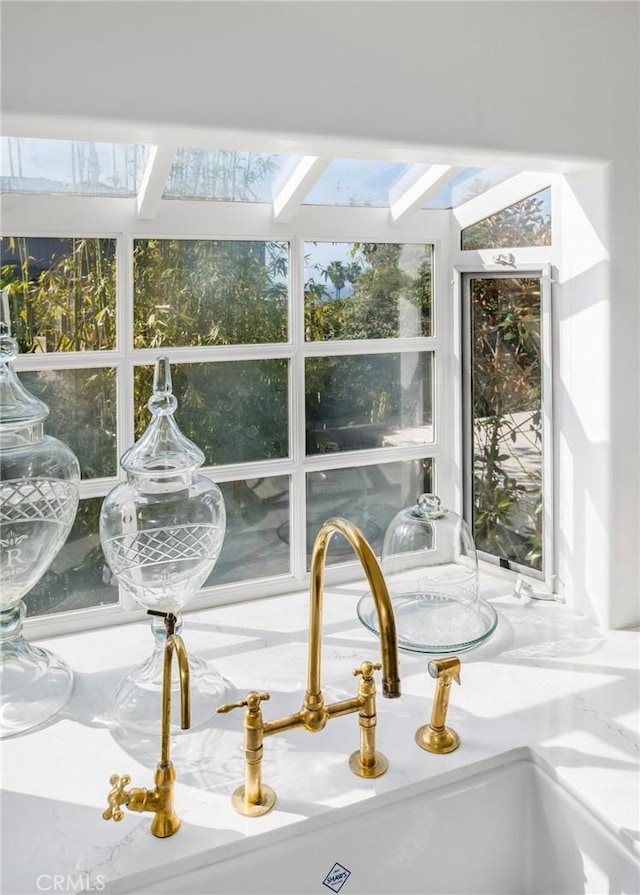 sunroom / solarium featuring a skylight and sink