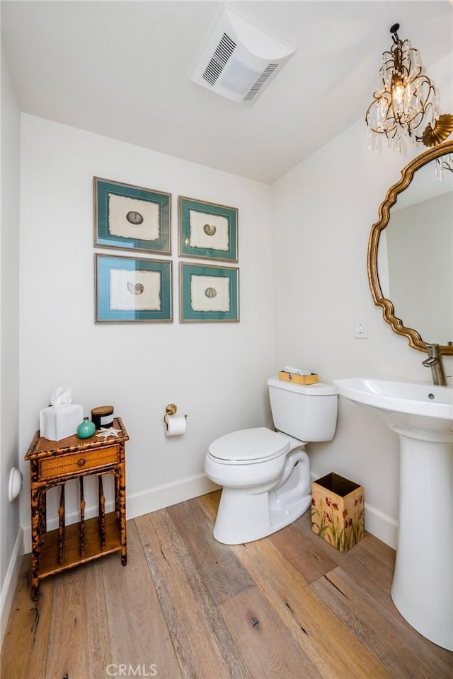 bathroom with sink, hardwood / wood-style flooring, and toilet