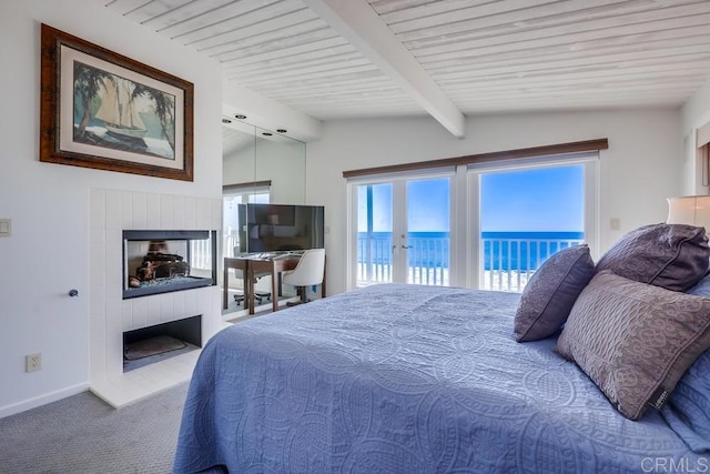 carpeted bedroom featuring lofted ceiling with beams and access to exterior