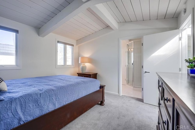 bedroom featuring ensuite bathroom, vaulted ceiling with beams, and light carpet