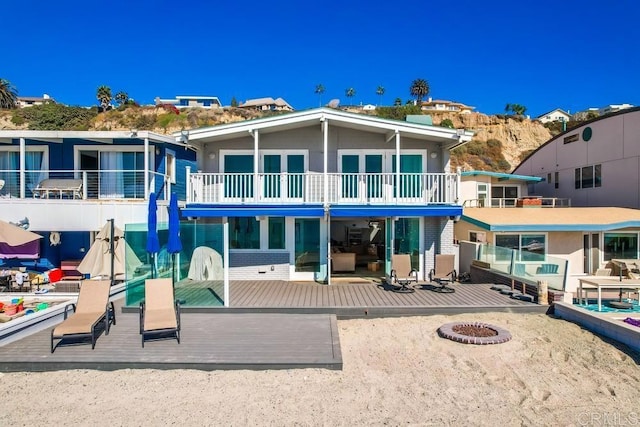 rear view of property featuring an outdoor fire pit