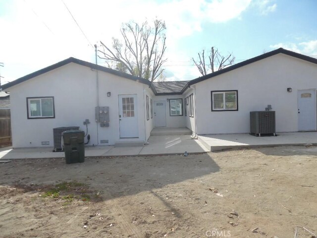 rear view of property featuring cooling unit and a patio area