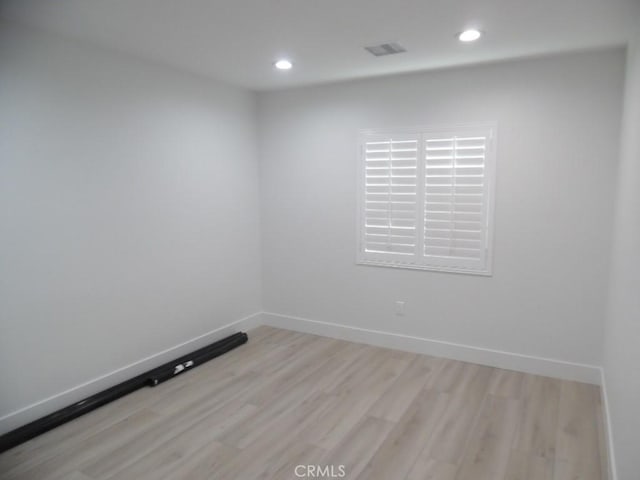 spare room featuring light hardwood / wood-style flooring