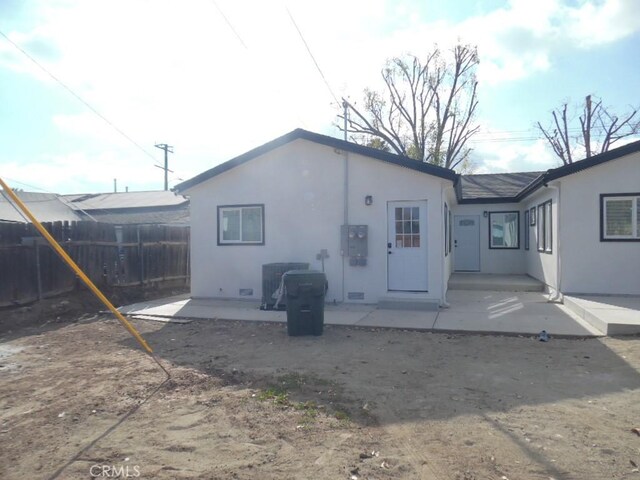 rear view of property featuring a patio area and central air condition unit