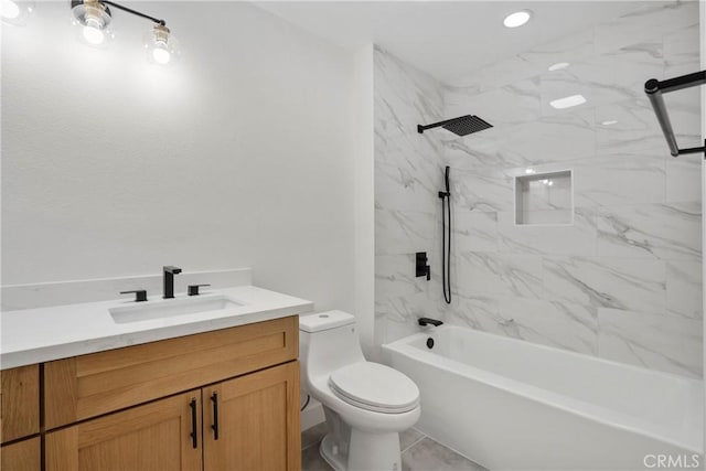 full bathroom with tile patterned flooring, vanity, tiled shower / bath, and toilet